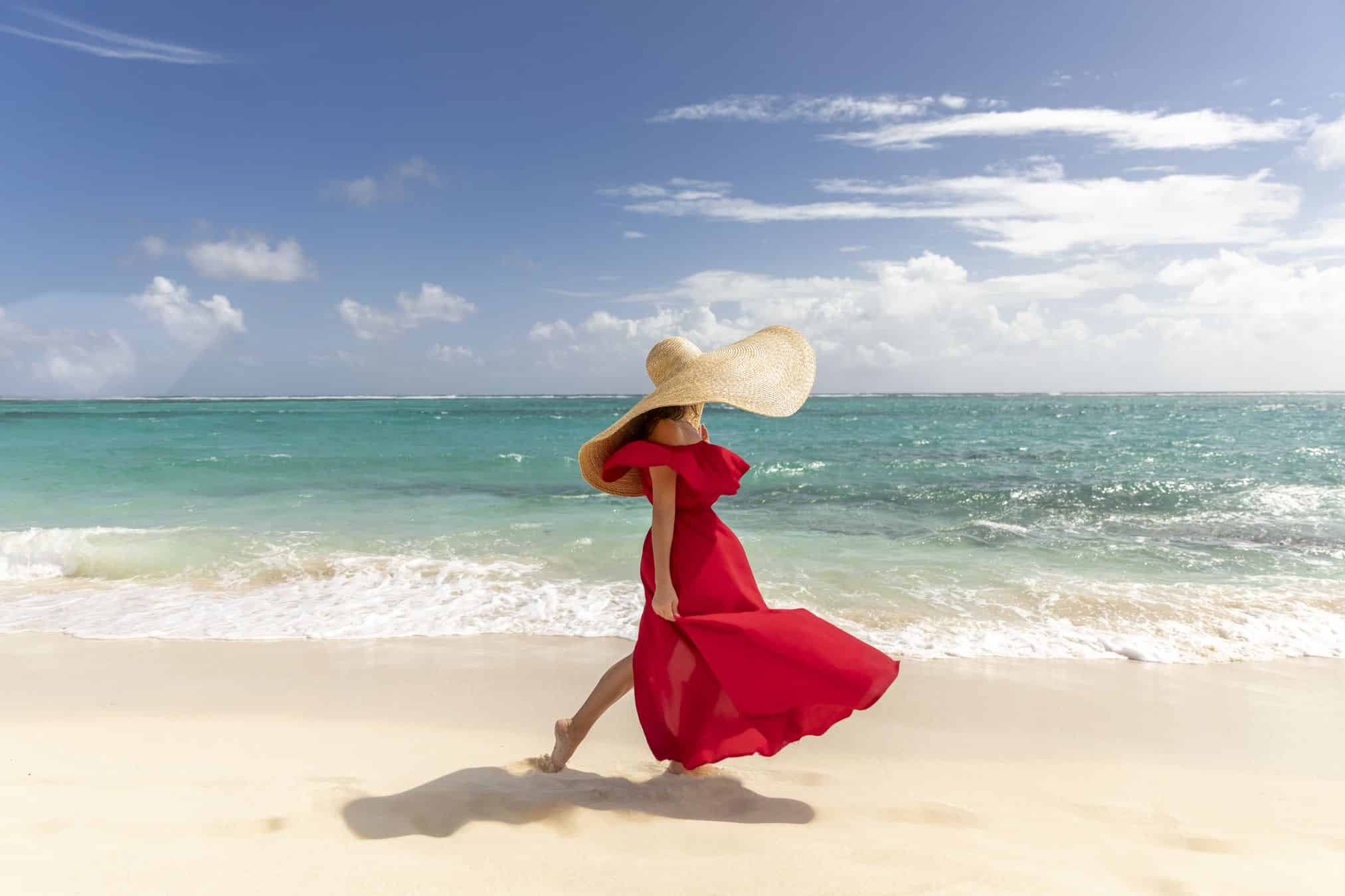 woman walking the St. James Point beach at Mandarin Oriental Grand Cayman.